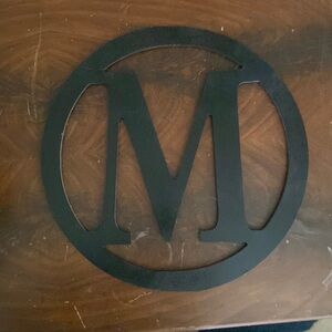 Black wooden letter M.
